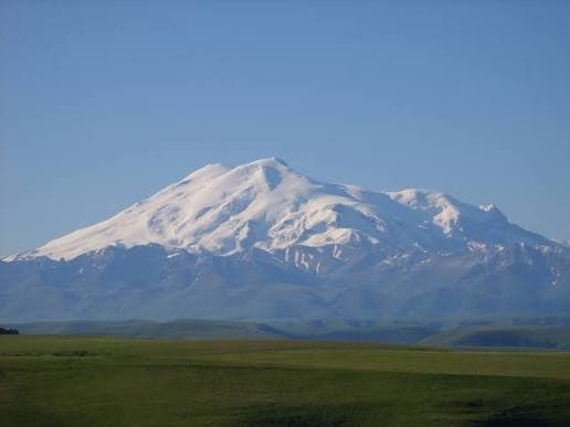Mount Elbrus, the twin snow-covered summits of Europe's highest volcano rising above glaciers in the Russian Caucasus