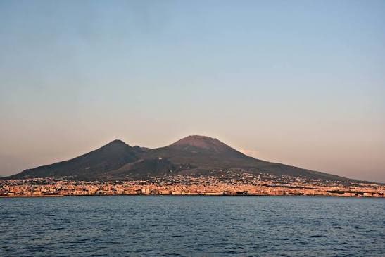 Mount Vesuvius, the dark volcanic cone of the Gran Cono rising above the Bay of Naples in Italy